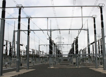 A vast electrical substation filled with various wires and poles, illustrating the network of power distribution