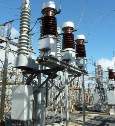 A large group of electrical transformers and wires arranged in an industrial setting, showcasing energy infrastructure