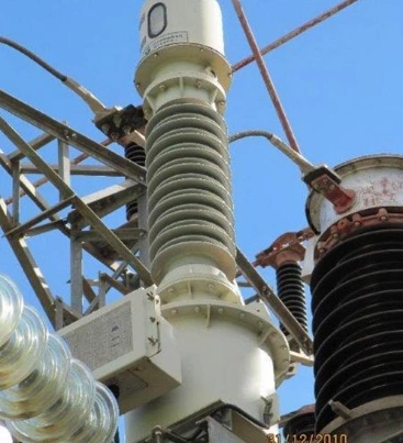 A large electrical transformer surrounded by numerous wires and cables, showcasing its complex connectivity and structure